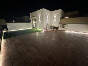 a night view of a house with a tile floor at studio at Beverly hills , shiekh zayed For families or individuals in Sheikh Zayed