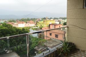 a view of a city from a balcony at Aarya Rishikesh - Luxurious 2 BHK in Rishīkesh