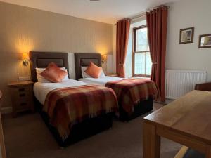 a hotel room with two beds and a window at Fort Charlotte Guest House in Lerwick
