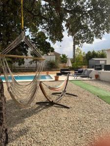 a hammock hanging from a tree next to a pool at Maison de vacances in Ventiseri +30 photos