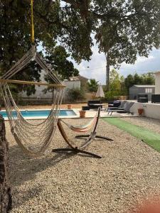een hangmat hangend aan een boom naast een zwembad bij Maison de vacances in Ventiseri