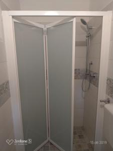 サンタ・クローチェ・カメリーナにあるI Dammusiのバスルーム(ガラスドア付きのシャワー付)