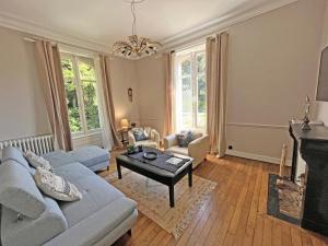 a living room with a couch and a table at VILLA MEGUINELLE in Grand-Fougeray
