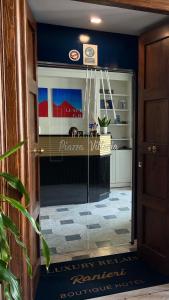 a hallway with blue walls and a glass door at Relais Ranieri Piazza Vittoria in Naples