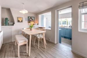a kitchen with a table and chairs in a room at Wonderful cottage with sun-filled terrace in Aldringham