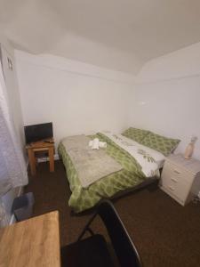 a bedroom with a bed with a chair and a desk at HESFORD (A) in Manchester