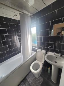 a bathroom with a white toilet and a sink at HESFORD (A) in Manchester