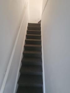 a stair case in a building with black stairs at HESFORD (A) in Manchester