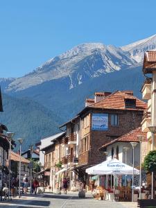 a street in a town with a mountain in the background at Studio in Cedar Lodge 3 in Bansko