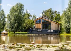 a house in the middle of a pond with lilies at Amazing Home In Boston With Wifi in Boston