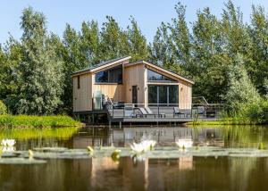 a house on the water with lilies in the foreground at Amazing Home In Boston With Wifi in Boston