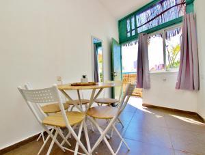 a dining room with a table and chairs at beautiful 3 rooms apartment at neve tzedek in Tel Aviv