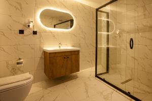 y baño con aseo, lavabo y ducha. en Grand Business Hotel, en Trabzon