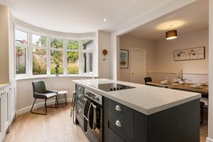 a kitchen with a black island and a table at Home away from home in Sheffield