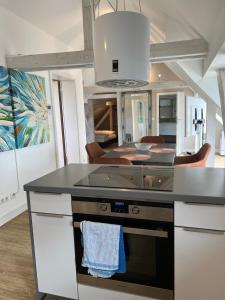 a kitchen with an island with a stove top oven at Lindenau Inn in Leipzig