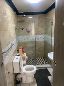 a bathroom with a toilet and a shower at 11 on CROMPTON OVERPORT HALAAL in Durban