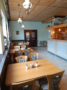 a dining room with wooden tables and chairs at Pension Thüringer Wald in Reichmannsdorf