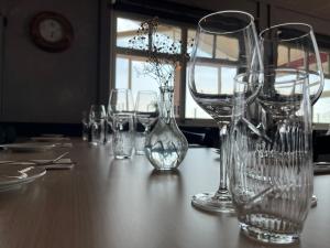 a table with several empty glasses on it at Herøy Brygge 