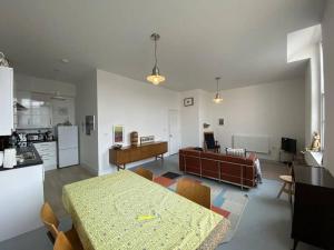 a kitchen and living room with a table and a couch at 2-bed in central Margate in Kent