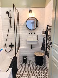 a bathroom with a tub and a sink and a mirror at Anouste Lou Bercail - cocon entièrement rénové avec vue sur la montagne in Campan