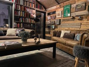 a living room with a couch and a coffee table at Maison Sur Véranda in Courzieu