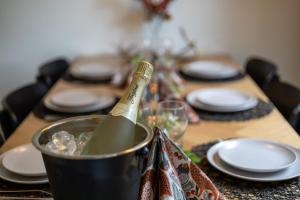 a table with a bottle of wine in a bucket at Apartment Naavis in Rovaniemi