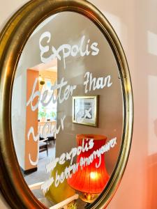 a mirror with the words expots better than anything at Expolis Residence - City Center MTP TARGI- Reception 24h in Poznań