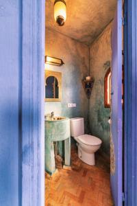 a bathroom with a sink and a toilet at Dar Zambra in Chefchaouene