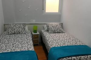 two beds sitting next to each other in a room at Oceanográfico, Playa, Puerto Juanjo in Valencia