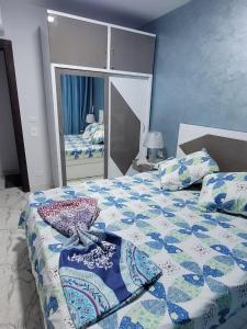 una camera con un letto con una trapunta sopra di الشاليه الملكى غرفتين وصاله vip منتجع بورتو سعيد a `Ezbet Shalabi el-Rûdi