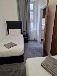 a hotel room with two beds and a window at Luna Apartments Newcastle Gateshead 3 in Gateshead