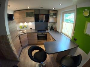 a small kitchen with a table and two chairs at Apartmenthaus zum Birnbaum in Ansbach