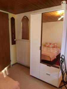 a bedroom with a bunk bed with a mirror at Ferienzimmer Appenzell in Appenzell