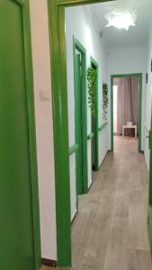 a hallway with green and white walls and wooden floors at Playa Sant Adrià de Besos in Sant Adria de Besos