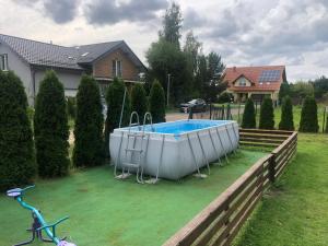 a large tub sitting in a yard next to a house at Apartament Zen in Sobieszewo