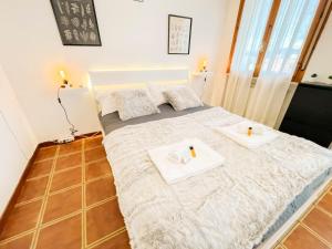 una camera da letto con 2 asciugamani bianchi su un letto di [Ospedale Cisanello] Bonsai House a Pisa