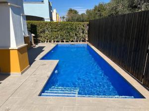 a small blue swimming pool next to a fence at Villa Alegre - 2 bed villa with private heated pool on Mar Menor Golf - family friendly in Torre-Pacheco