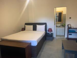 Postel nebo postele na pokoji v ubytování Cozy Homestay