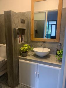 a bathroom with a sink and a mirror at Cozy Homestay in Ella