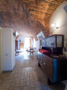 a living room with a wooden ceiling and a dining room at CASA DI LUCA in Stezzano