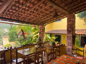 a dining room with a table and chairs on a patio at Pousada Lavramor in Lençóis