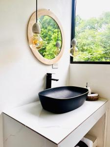 a bathroom with a black tub on a counter with a mirror at Deluxe Loft 1 BDR con linda vista in Puntarenas