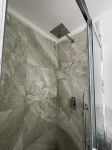 a shower with a glass door in a bathroom at Crystal in Santo Stefano al Mare
