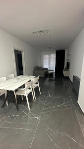 a living room with a table and a couch at Sole apartments in Shëngjin