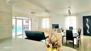 a large living room with a table and chairs at White Residence in Quatre Bornes