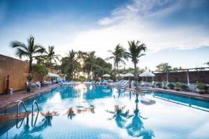 a large swimming pool with palm trees in the background at Twin Palms Resort Pattaya, SHA Extra Plus Certified in Pattaya