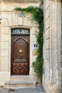 a large wooden door on the side of a building at Le Clos Saluces in Avignon