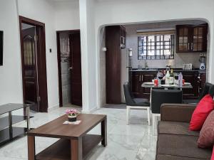 a living room with a couch and a table at Cozy Quiet & Fantastic- Close to Highway - Parking in Apenkwa +17 photos