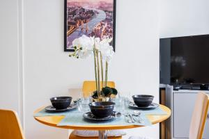 a dining room table with plates and bowls on it at One Bedroom Near Russell Square in London
