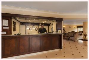 a man standing behind a bar in a hotel lobby at deniz otel in Istanbul